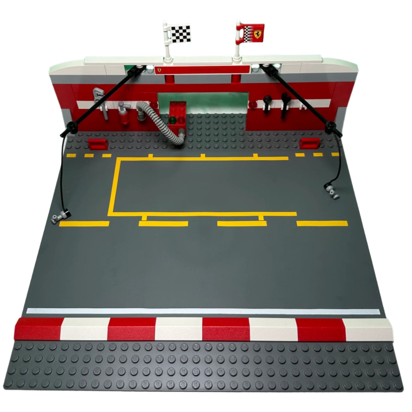 LEGO model of a race track with a garage and flags