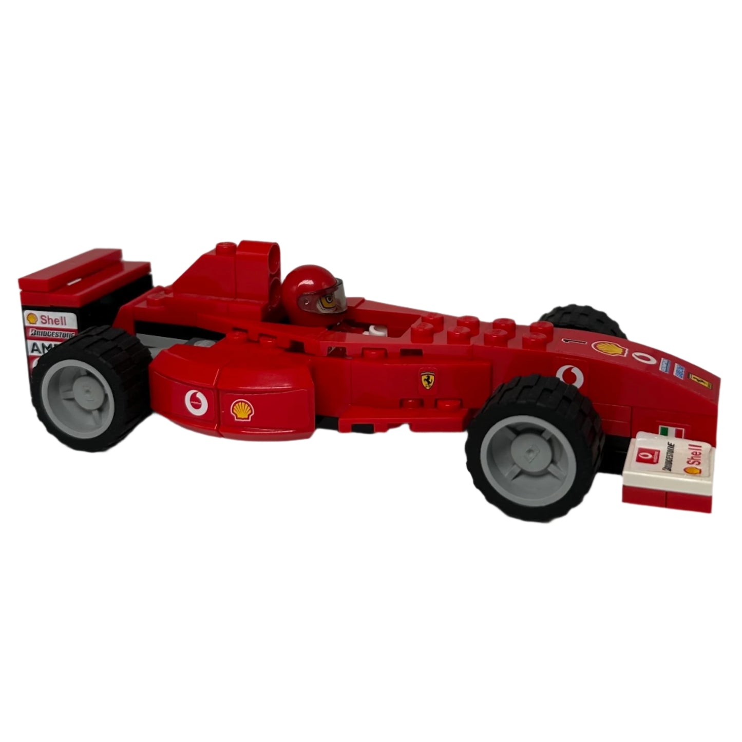 Red toy Formula 1 car with visible branding