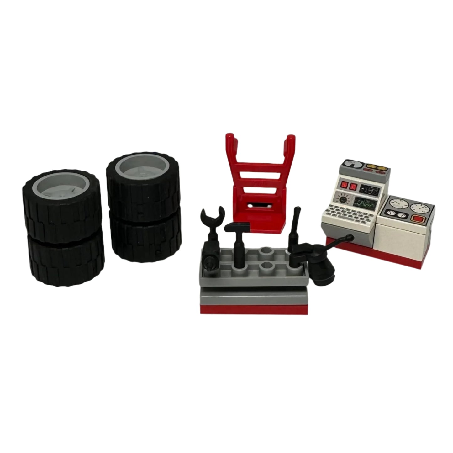 Set of LEGO pieces including tyres, tools, and computer