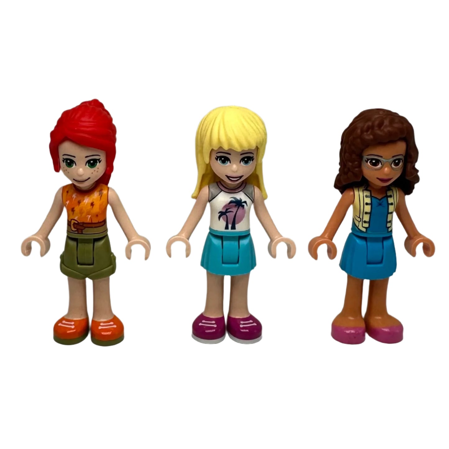 Three lego minifigures with different hairstyles and outfits
