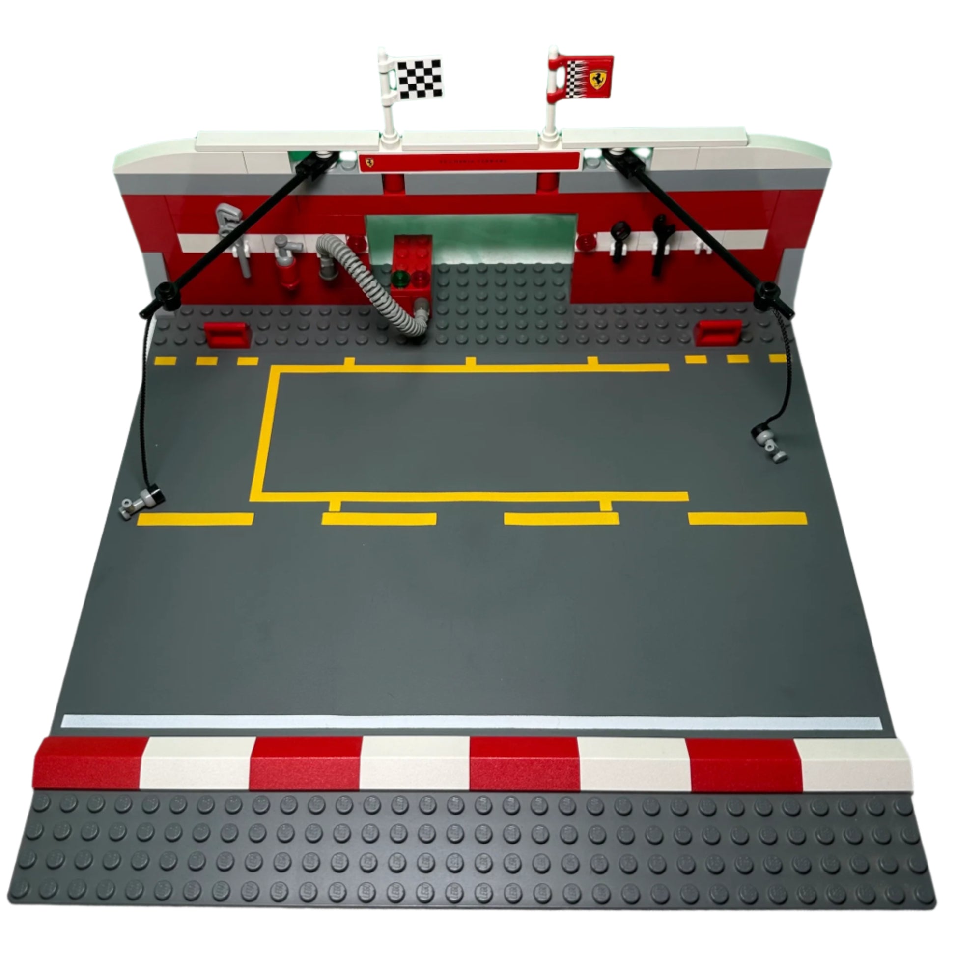 LEGO model of a race track with a garage and flags