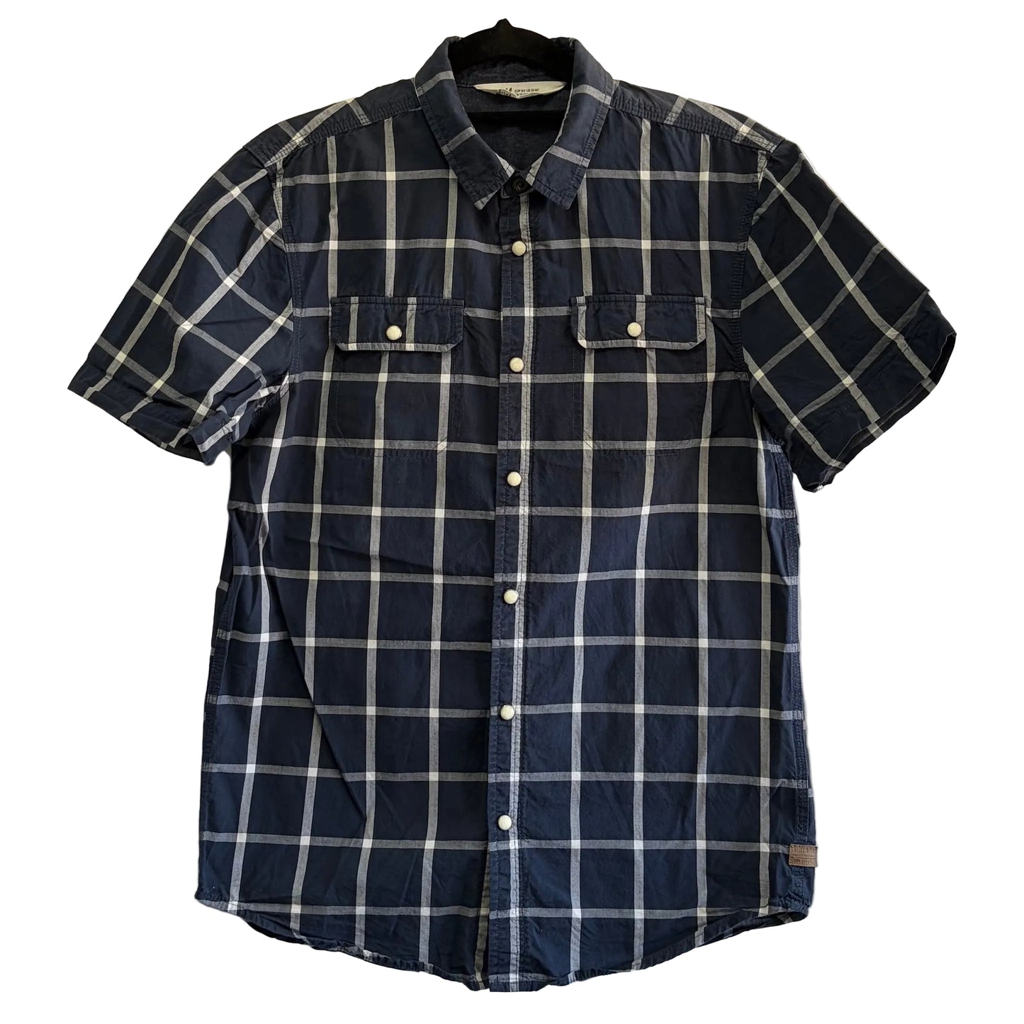 Navy and white checkered shirt on a hanger against a white fabric background